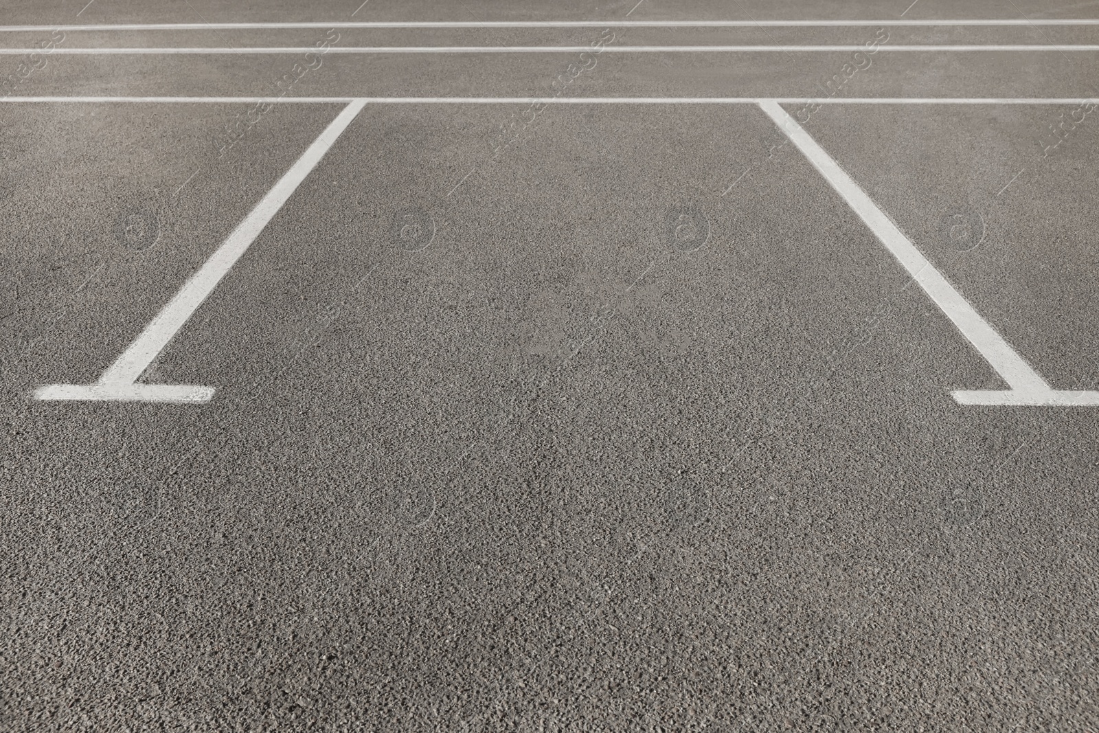 Photo of Outdoor car parking lot with white marking lines 