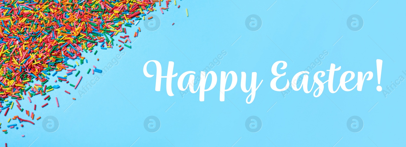 Image of Text Happy Easter and colorful sprinkles on light blue background, flat lay. Confectionery decor