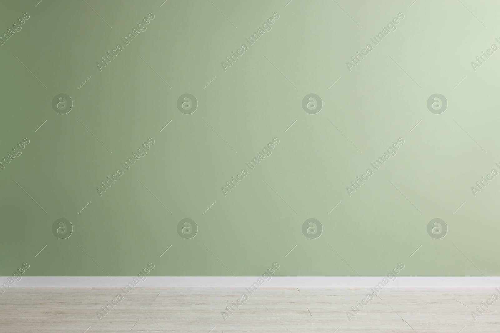 Photo of Empty room with green wall and wooden floor