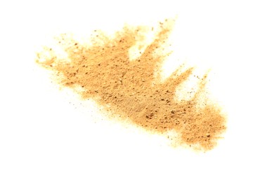 Photo of Pile of brown dust scattered on white background