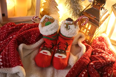 Photo of Stockings with sweets on plaid. Saint Nicholas Day tradition