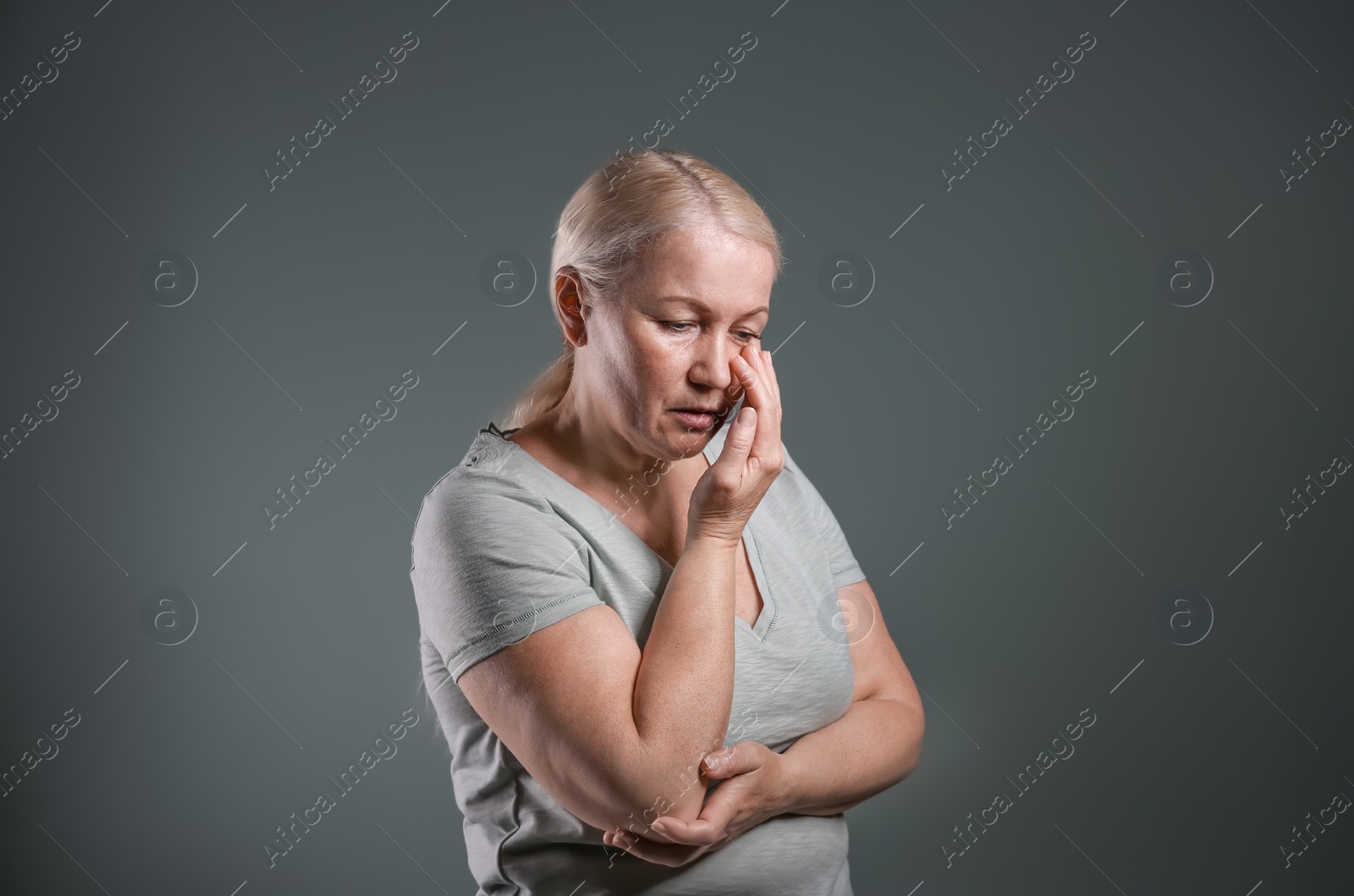 Photo of Mature woman suffering from depression on grey background