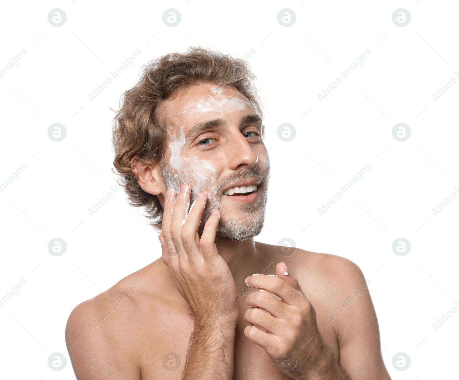 Photo of Young man washing face with soap on white background