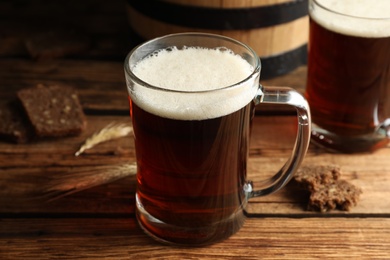 Photo of Delicious kvass, bread and spikes on wooden table