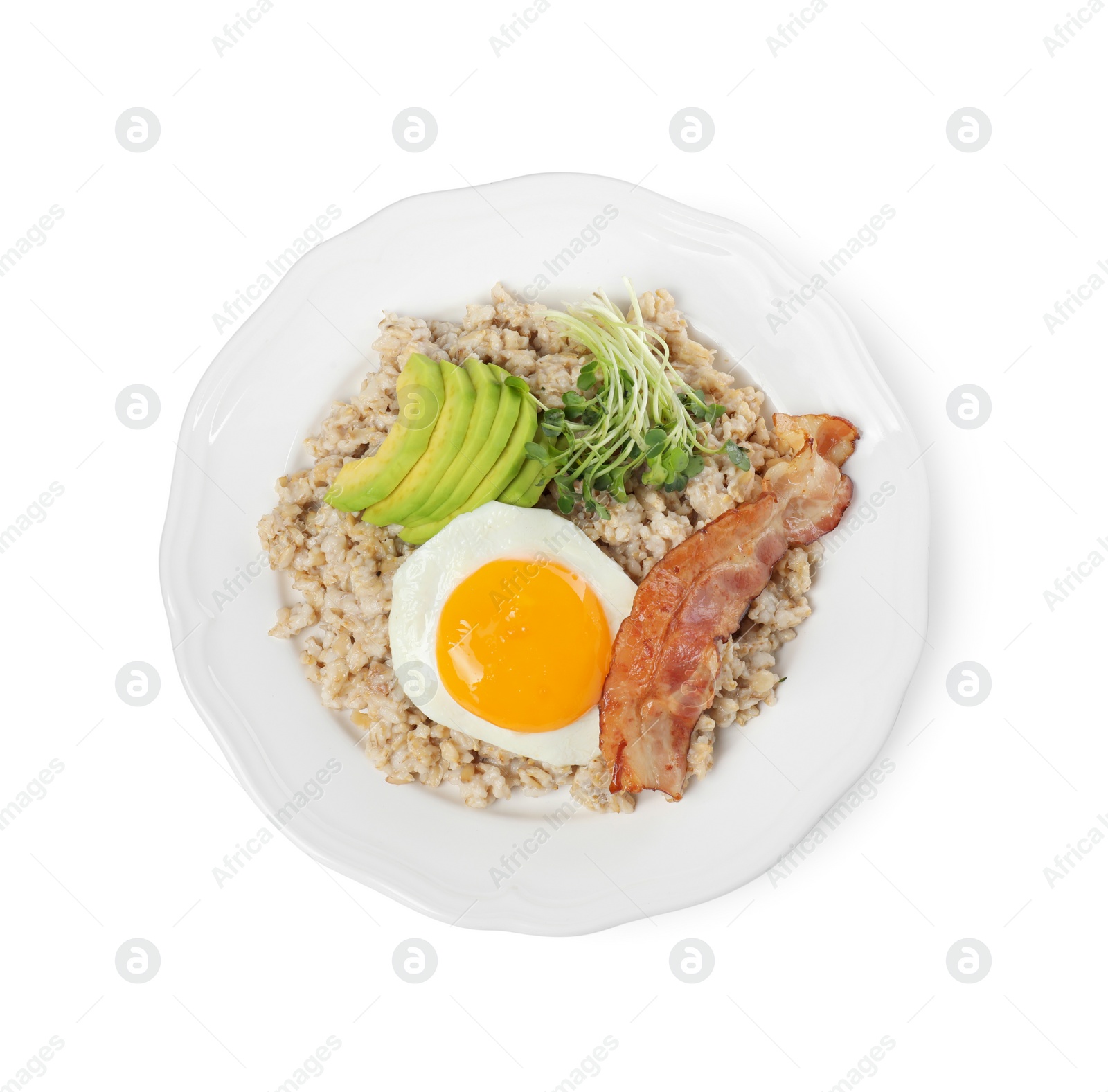 Photo of Tasty boiled oatmeal with fried egg, avocado and bacon isolated on white, top view