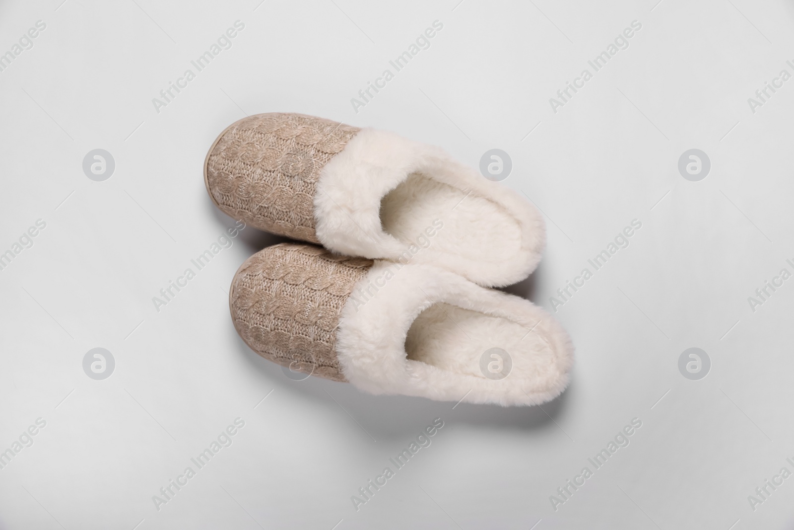 Photo of Pair of beautiful soft slippers on white background, top view