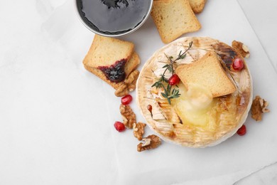 Photo of Flat lay composition with tasty baked camembert on white table. Space for text