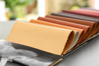 Leather samples of different colors for interior design on table