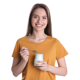 Young attractive woman with tasty yogurt on white background