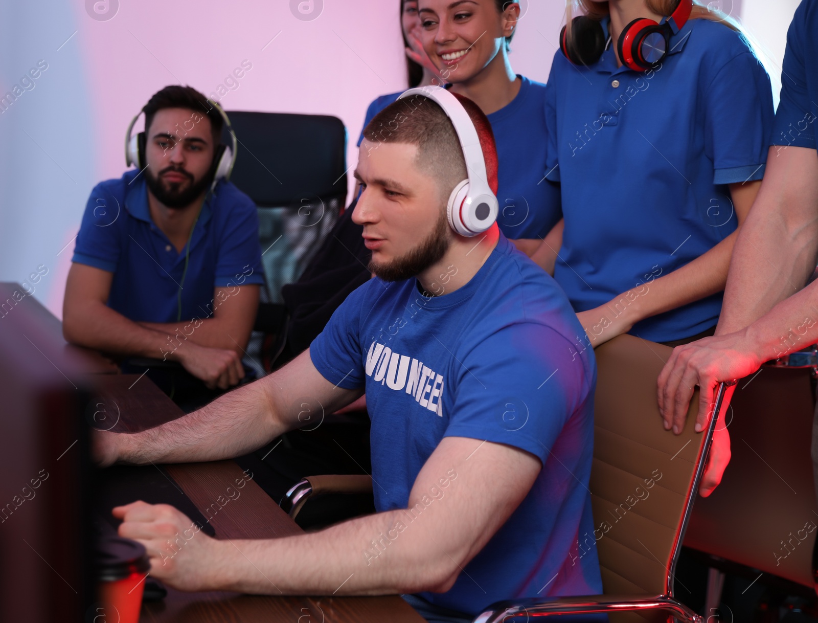 Photo of Young people playing video games on computers indoors. Esports tournament