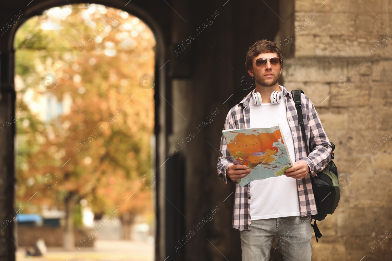 Photo of Traveler with world map on city street