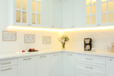 Blurred view of modern kitchen interior with stylish furniture