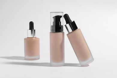 Bottles of skin foundation on white background. Makeup product