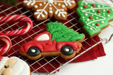 Photo of Tasty homemade Christmas cookies and candy canes on white table, closeup