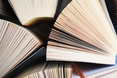 Photo of Collection of different books on white shelf, above view