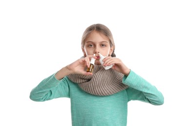 Photo of Sick little girl using nasal sprays on white background