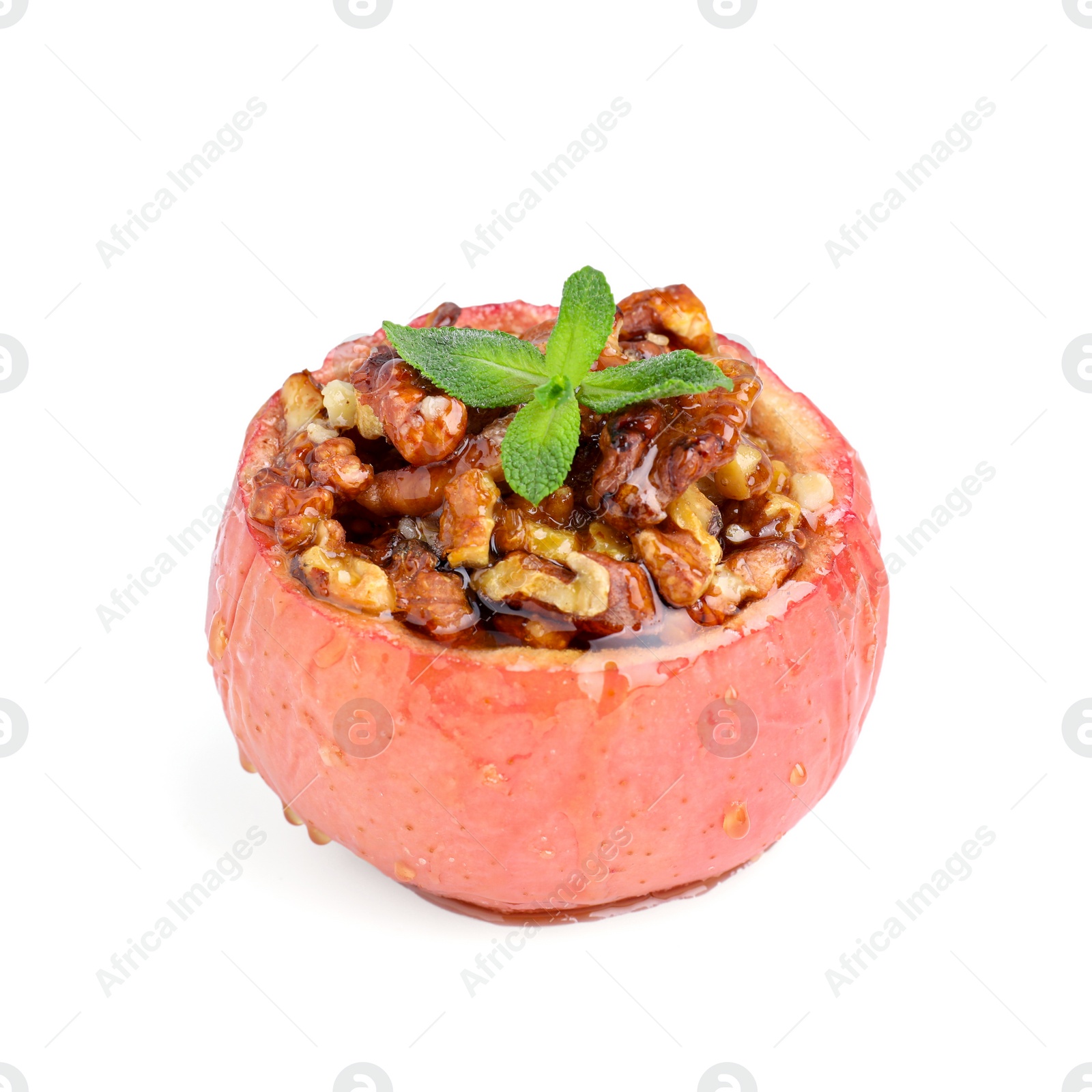 Photo of Tasty baked apple with nuts, honey and mint isolated on white