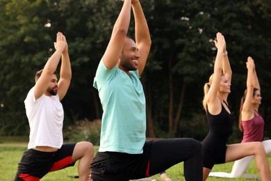 Photo of Group of people practicing yoga in park