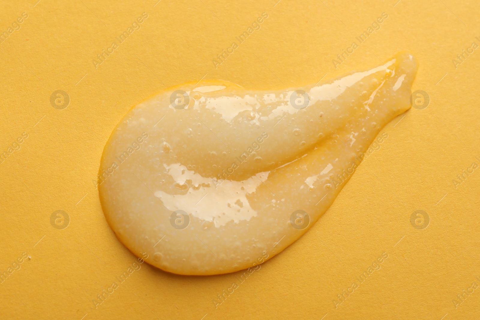 Photo of Sample of scrub on orange background, top view