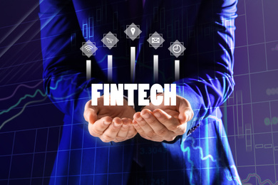 Image of Fintech concept. Man demonstrating different icons, closeup