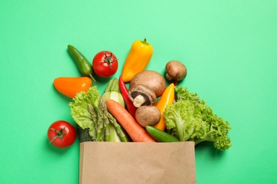 Photo of Different fresh vegetables on green background, flat lay