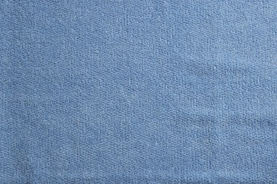 Photo of Soft blue towel as background, top view