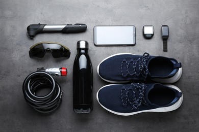 Photo of Flat lay composition with different cycling accessories on grey background