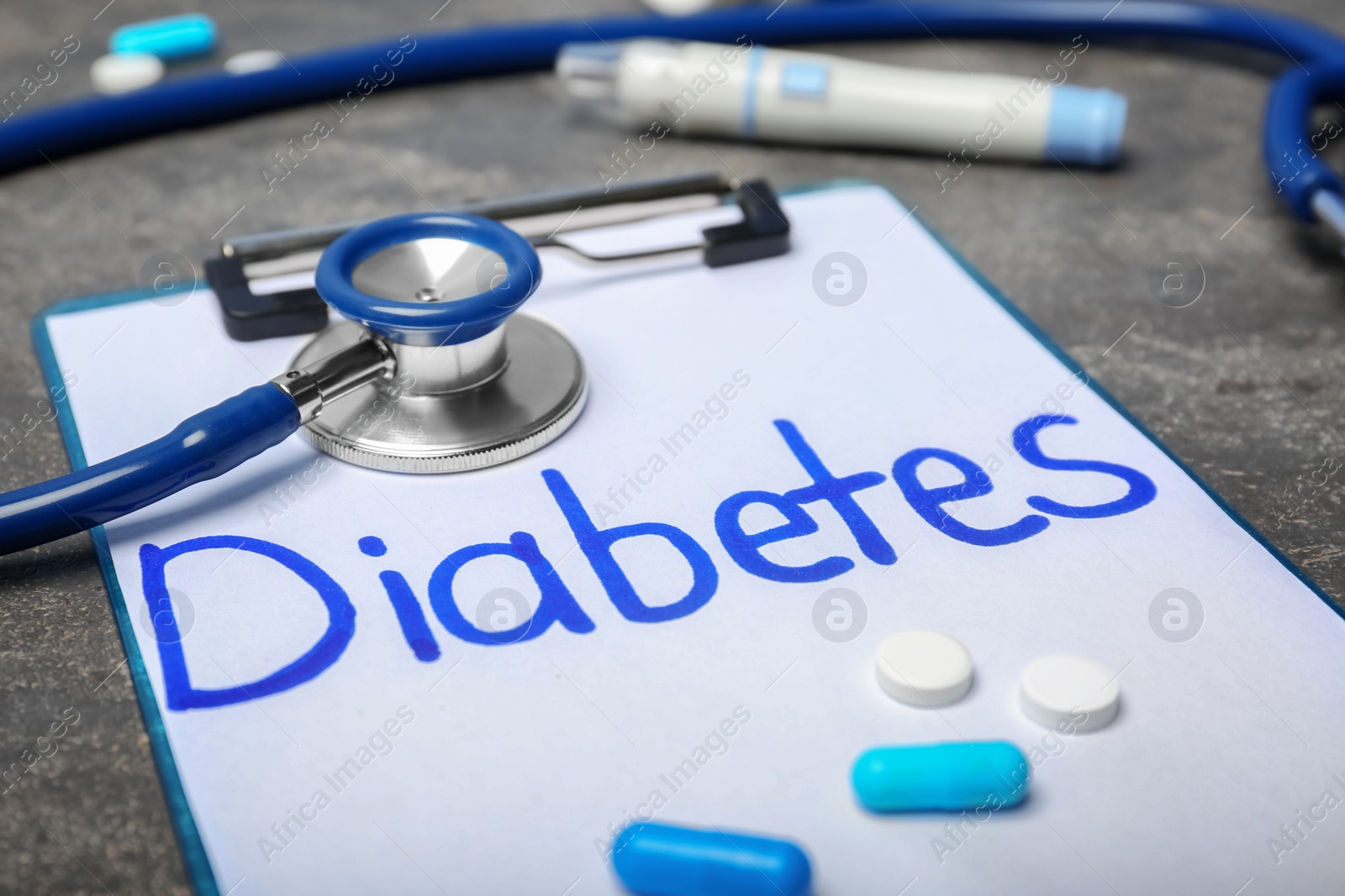 Photo of Composition with word "Diabetes",  stethoscope and medicine on table