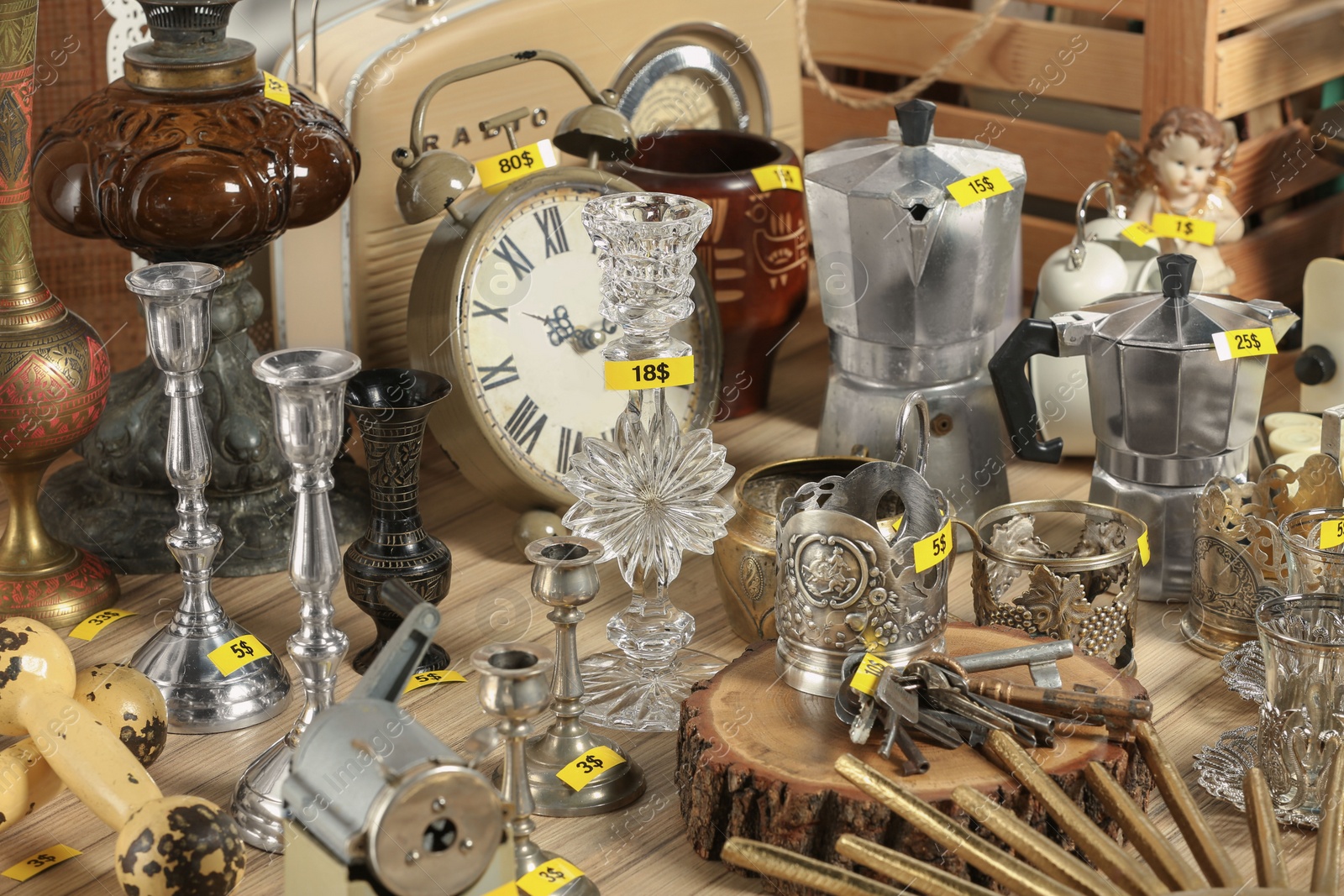 Photo of Many different items on wooden table. Garage sale