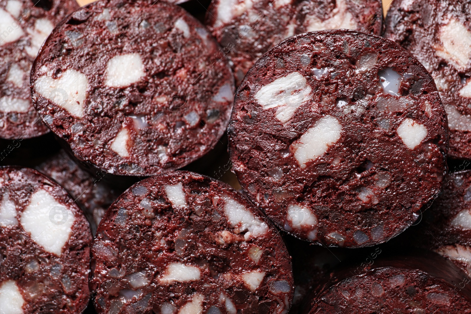 Photo of Slices of tasty blood sausage as background, top view