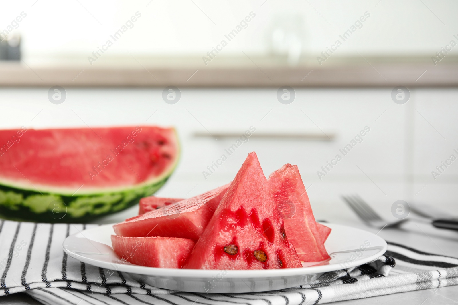 Photo of Yummy cut watermelon on table in kitchen, closeup