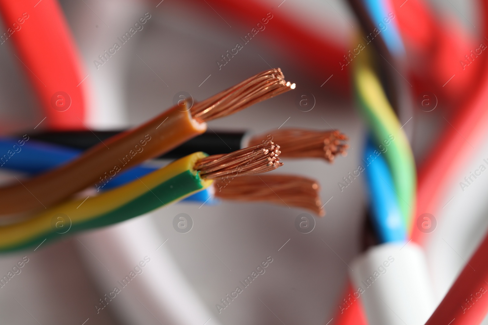 Photo of Colorful electrical wires on blurred background, closeup