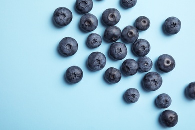 Photo of Flat lay composition with tasty blueberry and space for text on color background