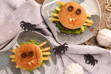 Photo of Flat lay composition with tasty monster sandwiches for Halloween party on wooden table