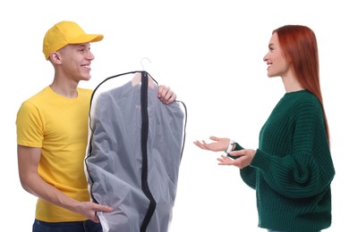 Dry-cleaning delivery. Courier giving garment cover with clothes to woman on white background