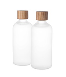 Bottles of essential oil on white background