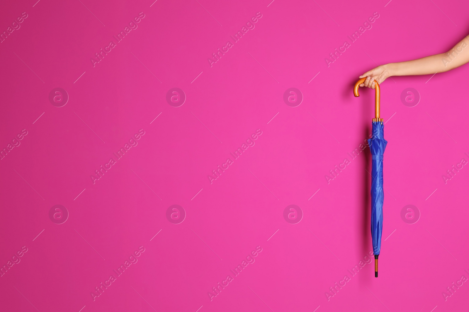 Photo of Woman holding beautiful umbrella on color background with space for design