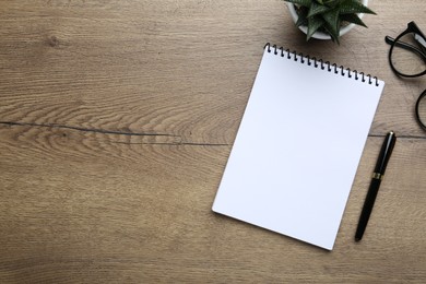 Flat lay composition with notebook on wooden table