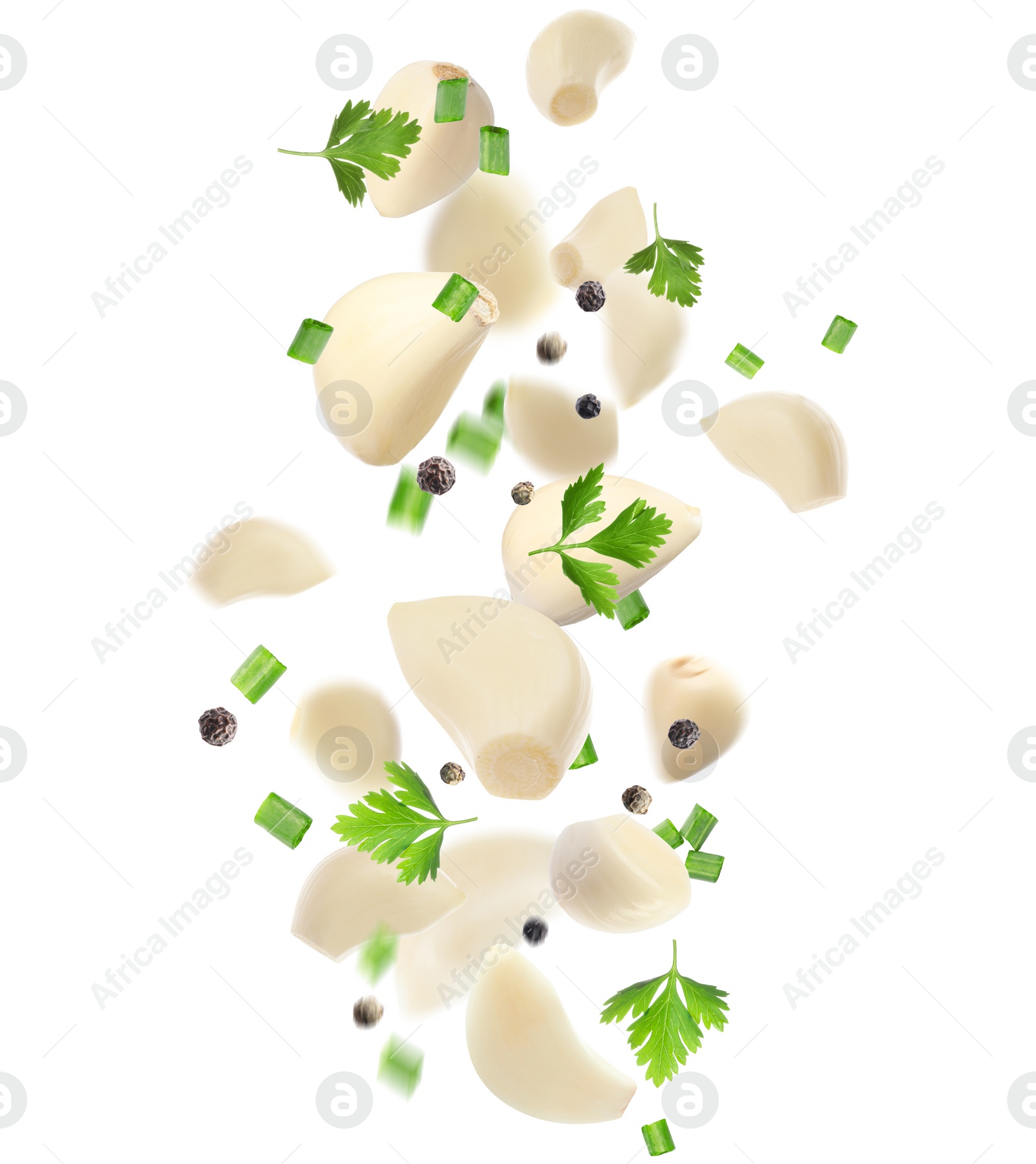 Image of Fresh peeled garlic cloves, peppercorns and parsley flying on white background