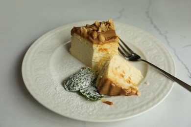 Photo of Tasty dessert and fork on white marble table