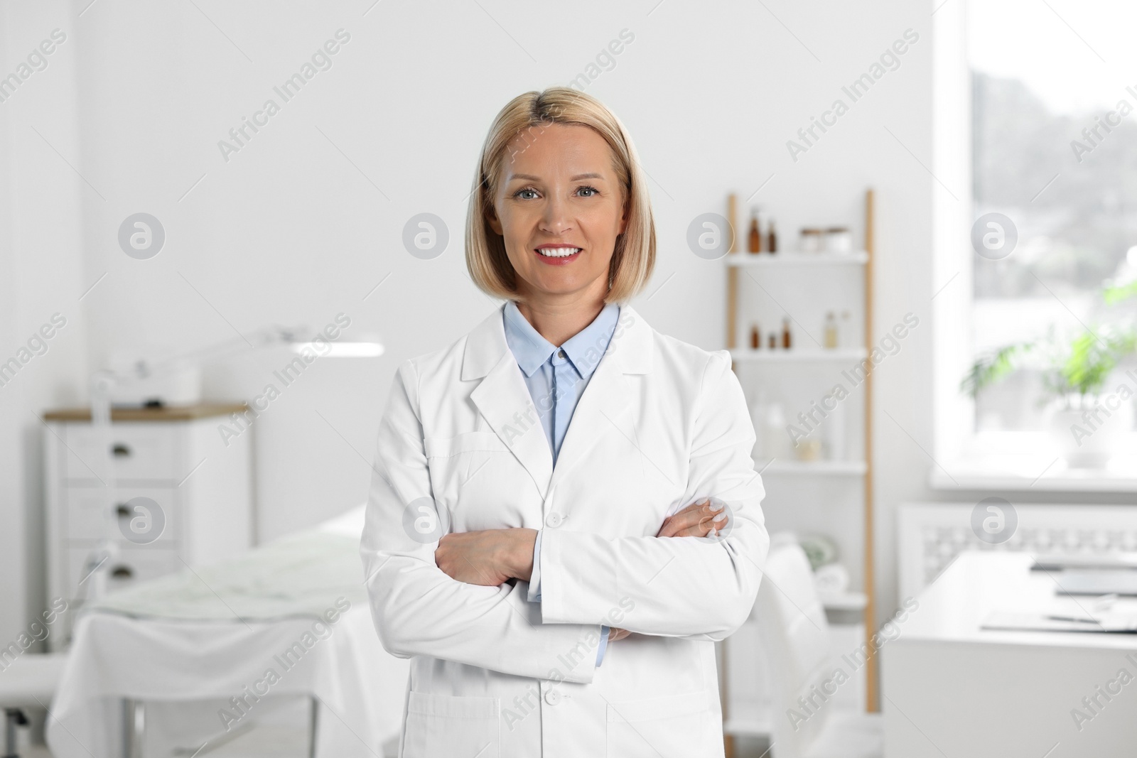 Photo of Portrait of happy dermatologist in modern clinic