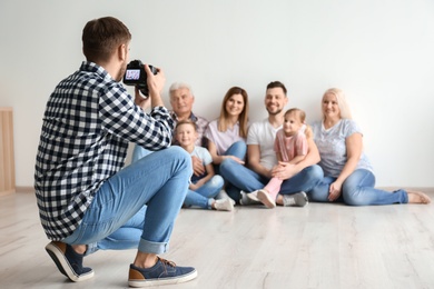 Professional photographer taking photo of family in studio