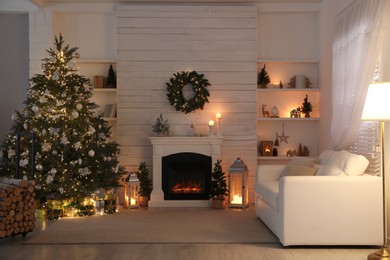 Photo of Stylish living room interior with decorated Christmas tree and comfortable sofa