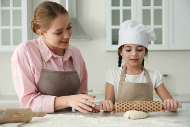 Photo of Mother and daughter cooking together in kitchen