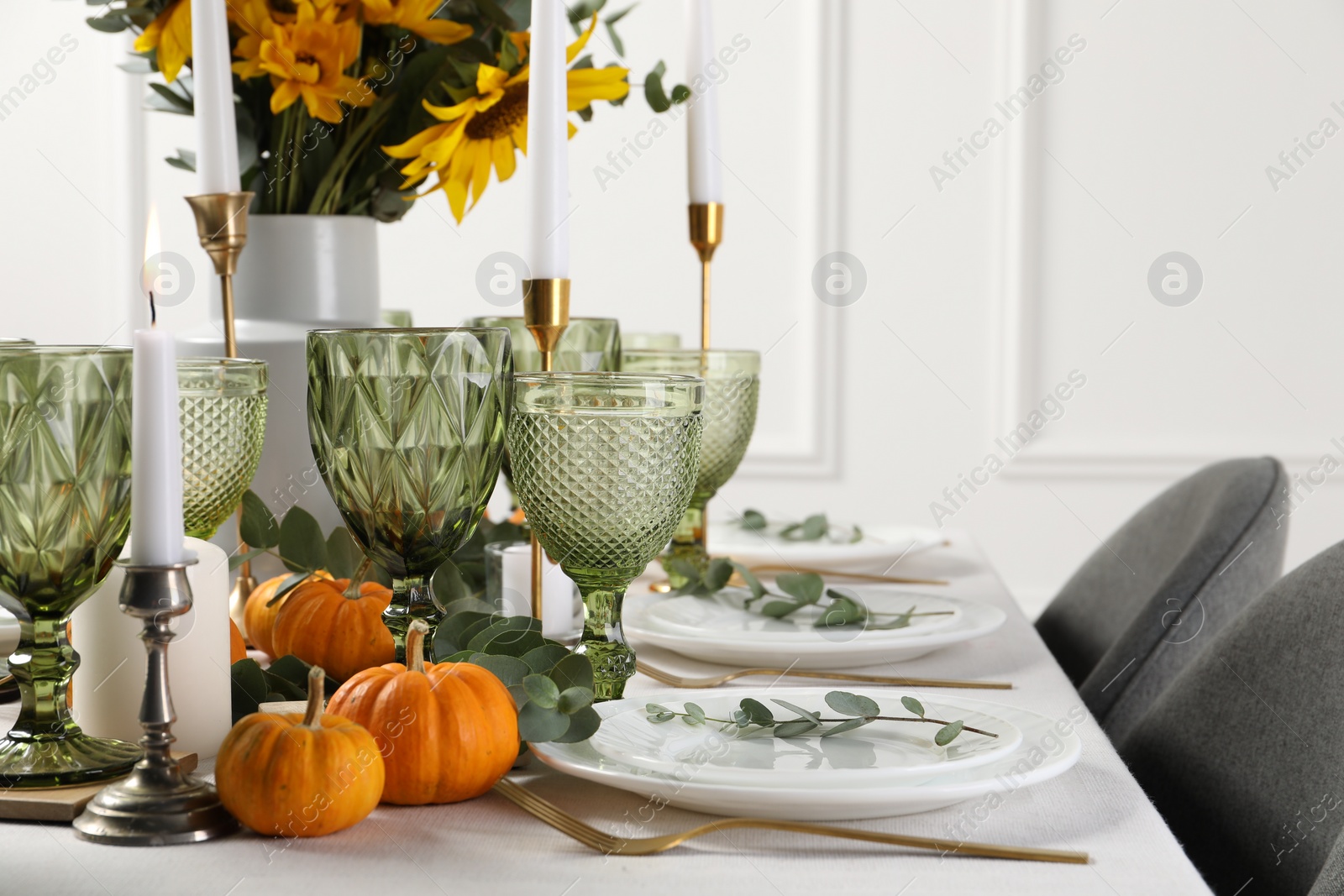 Photo of Beautiful autumn table setting with bouquet indoors. Plates, cutlery, glasses and floral decor