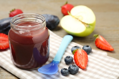 Photo of Healthy baby food and fresh ingredients on wooden table