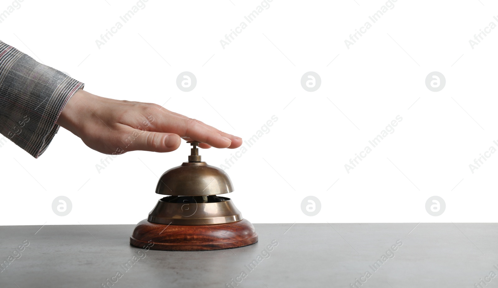 Photo of Woman ringing hotel service bell at grey stone table