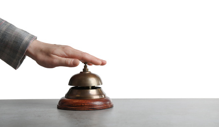 Photo of Woman ringing hotel service bell at grey stone table