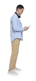 Photo of Young man with headphones using mobile phone on white background