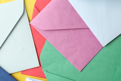 Photo of Colorful paper envelopes as background, top view